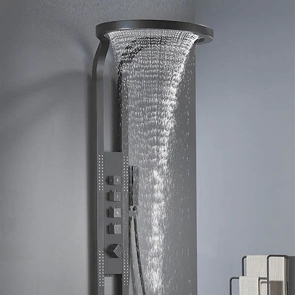 Ceiling-mounted shower head with water flowing against a gray background